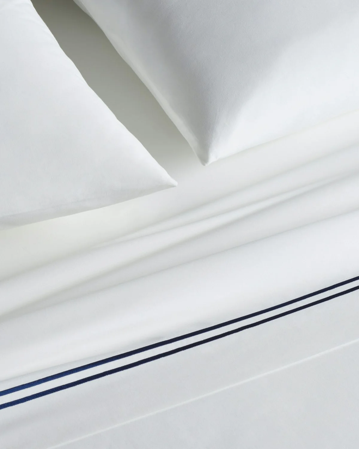 Luxe Premium Percale Bed Sheets in White with Navy Embroidered Border - Image 3