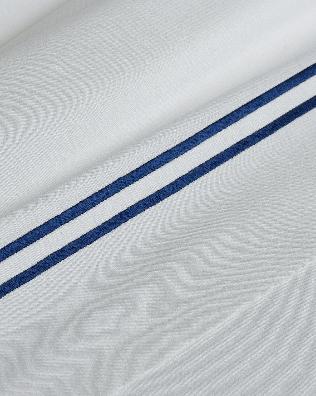Luxe Premium Percale Bed Sheets in White with Navy Embroidered Border - Image 4